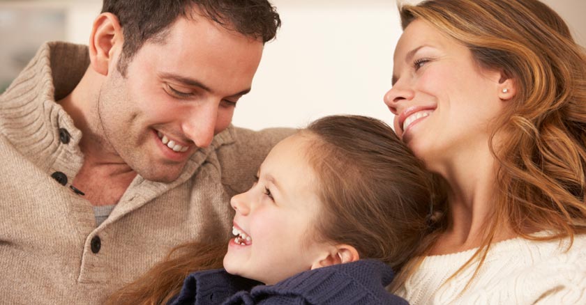 papa y mama sonriendo con su pequena hija felices los tres dia 